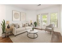 Bright living room featuring a neutral palette, stylish furnishings, and a glass door leading to an outdoor space at 1850 Cotillion Dr # 4218, Atlanta, GA 30338