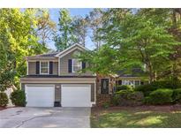 Charming two-story home with a two-car garage and beautifully landscaped front yard at 4856 Saddlerun Ln, Powder Springs, GA 30127