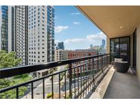 Condo balcony with metal railing offering city views and an outdoor seating area at 3481 Lakeside Ne Dr # 1103, Atlanta, GA 30326