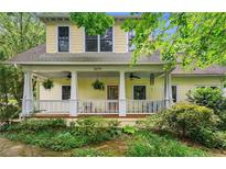 Charming home featuring a welcoming front porch with ceiling fans and meticulously landscaped surroundings at 2655 Appian Way, Decatur, GA 30030