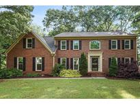 Charming two-story brick home featuring classic black shutters and a well-maintained lawn at 3267 Rememberance Trce, Lawrenceville, GA 30044
