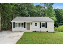 Charming bungalow-style home with a well-maintained lawn and a welcoming front entrance at 1980 Oakdale Se Ct, Smyrna, GA 30082