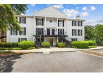 Inviting two-story building with manicured shrubs and mature trees at 1101 Collier Rd # K2, Atlanta, GA 30318