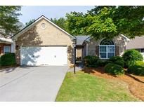 Charming brick home featuring a two-car garage and inviting front yard at 5251 Centennial Hill Nw Dr, Acworth, GA 30102