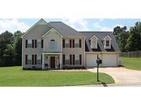 Charming two-story home featuring a well-manicured lawn and a two-car garage, perfect for suburban living at 80 Pine Valley Court, Hiram, GA 30141