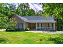 Well-maintained home featuring a covered front porch, lush lawn, and attractive landscaping at 2652 Mount Tabor Church Rd, Dallas, GA 30157