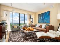 Bright living room features a large window with a stunning view and stylish, comfortable seating at 145 15Th Ne St # 1225, Atlanta, GA 30309