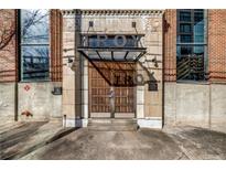 Stately stone and brick building entrance featuring wood doors and transom with industrial details at 650 Glen Iris Drive Ne # 27, Atlanta, GA 30308