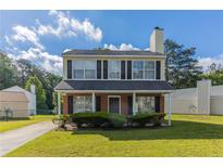Charming two-story home features a classic design and well-maintained front yard at 7623 Mcgillicuty Dr, Union City, GA 30291