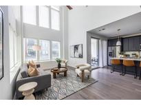 Bright living room with hardwood floors, high ceilings, and modern furniture at 399 Pratt Se Dr # 910, Atlanta, GA 30315