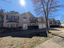 Charming two-story brick home with attached two car garage and well-maintained front lawn at 5622 Platte Dr, Ellenwood, GA 30294