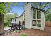 Beautifully renovated exterior with large windows and a charming front deck entrance at 104 River Creek Dr, Woodstock, GA 30188