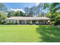 Charming single story home with a large yard and covered porch at 515 Houze Way, Roswell, GA 30076