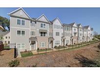 Row of attractive townhomes featuring neutral colors, and modern architectural details at 1923 Deco Dr, Kennesaw, GA 30144