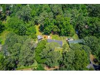 Secluded property featuring a long, private driveway and a lush wooded landscape, perfect for peaceful living at 3425 Poplar Dr, Lawrenceville, GA 30044