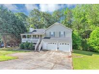 Charming home featuring a covered porch, two car garage and beautiful landscaping at 185 Wyngate Ct, Dallas, GA 30157