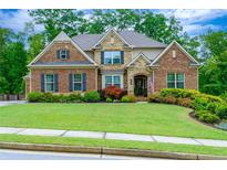 Charming brick home with a manicured lawn and well-maintained landscaping at 225 Sundance Dr, Woodstock, GA 30188