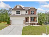 Charming two-story home with a manicured lawn, stone accents, and a two-car garage at 2889 Windsor Knoll Dr, Dacula, GA 30019