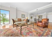 Bright living room with large windows, hardwood floors, and an ornate oriental rug and an adjacent dining room at 3475 Oak Valley Ne Rd # 950, Atlanta, GA 30326