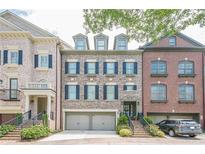 Charming brick townhome featuring a two-car garage and classic black shutters at 2295 Falmouth Se Ct, Smyrna, GA 30080