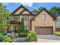 Beautiful two-story brick home featuring manicured landscaping, a two-car garage, and a welcoming front entrance at 3301 Chastain Ridge Dr, Marietta, GA 30066