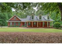 Charming brick home with a welcoming front porch and well-manicured lawn at 15 Walnut Ridge Way, Covington, GA 30014