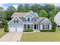 Charming two-story home with a well-manicured lawn and attached two-car garage at 214 Crestmont Way, Canton, GA 30114