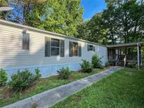 Exterior view of a manufactured home with a covered porch and a well-maintained yard at 4934 Pickys Se Holw, Acworth, GA 30102