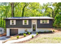 Stylish two-story home with a gray exterior, a front yard, and a garage at 809 Vinton Wood Rd, Forest Park, GA 30297