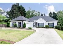 Charming single-story home featuring a beautifully maintained lawn and long driveway at 823 Laurel Crest Sw Ct, Marietta, GA 30064