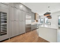 Spacious kitchen featuring a large island, stainless steel appliances, and a wine refrigerator at 71 Krog Ne St, Atlanta, GA 30307