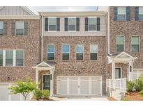 Stylish brick townhome with a two-car garage and well-maintained landscaping at 123 Matson Sw Run, Mableton, GA 30126