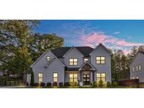 Stunning two-story painted brick home showcasing a symmetrical design and welcoming front entrance at 2381 Jones Phillips Rd, Dacula, GA 30019