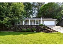 Charming single-story home with well-manicured lawn and rock garden at 755 Waterbrook Ter, Roswell, GA 30076