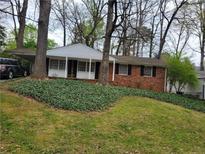 Charming brick home featuring a well-maintained lawn and inviting front porch at 2137 Plantation Ln, Chamblee, GA 30341