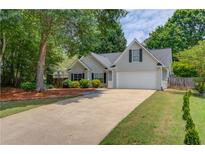 Charming single-Gathering home with a two-car garage and a well-maintained front yard at 627 New England Way, Lawrenceville, GA 30046