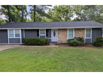 Charming single story home with a stone facade and a well-manicured front lawn, exuding curb appeal at 4448 Denise Dr, Decatur, GA 30035