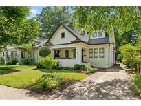 Charming renovated bungalow with fresh white paint, updated landscaping, and brick driveway at 622 Seminole Ne Ave, Atlanta, GA 30307