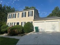 Charming two-story home with a two-car garage, manicured bushes and black shutters at 2584 Shadowbrook Dr, Decatur, GA 30034