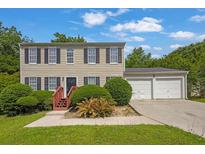 Charming two-story home with attached two-car garage and landscaped front yard at 2584 Shadowbrook Dr, Decatur, GA 30034