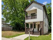 Charming two-story home featuring a covered porch, balcony, and modern farmhouse design elements at 515 Cohen St, Atlanta, GA 30310