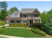 Beautiful brick home with manicured lawn and mature trees, offering classic elegance and curb appeal at 1393 Kings Park Nw Dr, Kennesaw, GA 30152