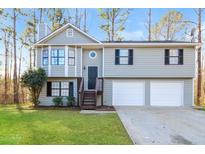 Charming two-story home featuring a two-car garage and a well-maintained lawn and traditional siding at 2235 Azalea Dr, Loganville, GA 30052