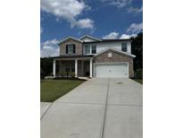 Charming two-story home with neutral brick, attached two car garage, and well-maintained lawn at 4477 Bethany Manor Dr, Snellville, GA 30039