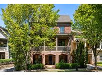 Charming two-story brick home with a covered front porch and mature trees offering shade at 970 N Ormewood Park Se Dr, Atlanta, GA 30316