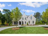 Stunning stone home with a manicured lawn, complemented by mature trees and a circular driveway at 126 Owens Mill Pl, Canton, GA 30115