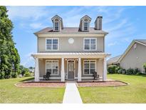 Charming two-story home with a welcoming front porch, perfect for relaxing outdoors at 2770 Nautical Way, Villa Rica, GA 30180