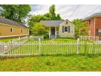 Charming home featuring a white picket fence and lush green lawn at 246 Stafford Nw St, Atlanta, GA 30314