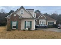 Charming single-Gathering home with brick and vinyl siding, complemented by green shutters and a well-manicured lawn at 127 Autumn Run Pl, Villa Rica, GA 30180