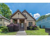 Charming two-story home featuring a welcoming front porch and beautifully landscaped yard at 3044 Dogwood Dr, Atlanta, GA 30354